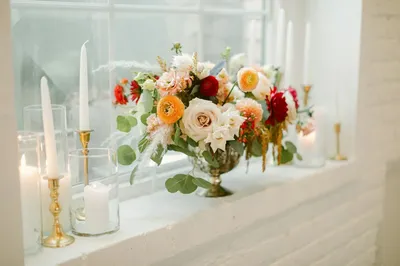 Garden roses and taper candles on a white table