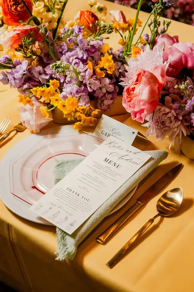 Place setting with a printed menu and flowers